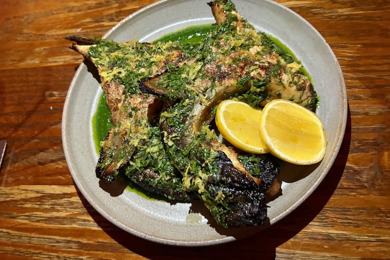 The grilled hamachi collars at Alice restaurant in the Italian Market are ideal for cooking onthe restaurant's coal-fired oven grill.