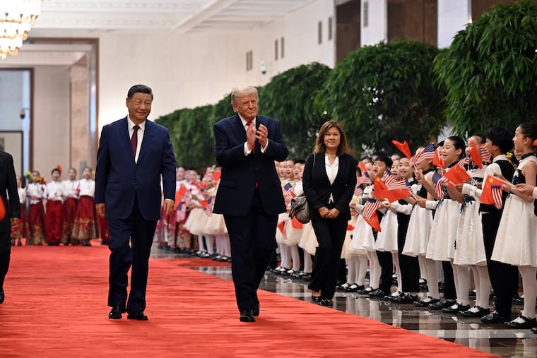 President Xi Jinping of China (left) escorts President Donald Trump to a welcome ceremony at the Great Hall of the People in Brijing on May 14, 2026. China on July 17, 2026, rejected Trump’s claim that it had meddled in American elections as baseless. But its response was relatively restrained.