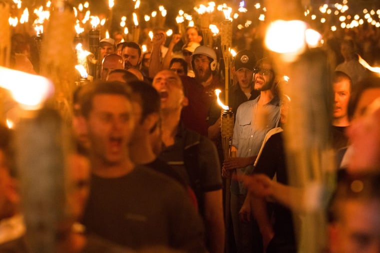 Neo-Nazis, alt-right supporters, and white supremacists march the night before the “Unite the Right” rally on Aug. 11 through the University of Virginia in Charlottesville.