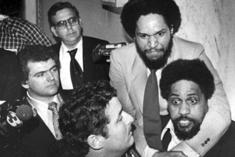 April 11, 1980: Councilman John Street (at top) and state Rep. Milton Street (right) take part in a near-riot in Council chambers. Sergeant-at-Arms Bob Brady (left) looks on. (Daily News File Photo)