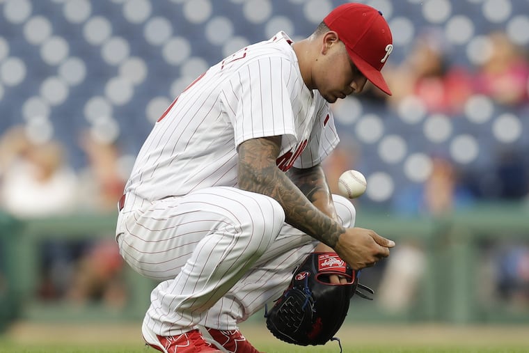 Phillies pitcher Vince Velasquez crouches after giving up a three-run home run in a loss to the Brewers on Friday.