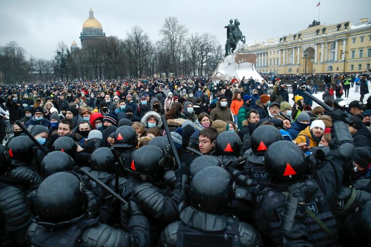 People clash with police during a protest against the jailing of opposition leader Alexei Navalny in St.Petersburg, Russia, Saturday, Jan. 23, 2021. Russian police on Saturday arrested hundreds of protesters who took to the streets in temperatures as low as minus-50 C (minus-58 F) to demand the release of Alexei Navalny, the country's top opposition figure. A Navalny, President Vladimir Putin's most prominent foe, was arrested on Jan. 17 when he returned to Moscow from Germany, where he had spent five months recovering from a severe nerve-agent poisoning that he blames on the Kremlin.