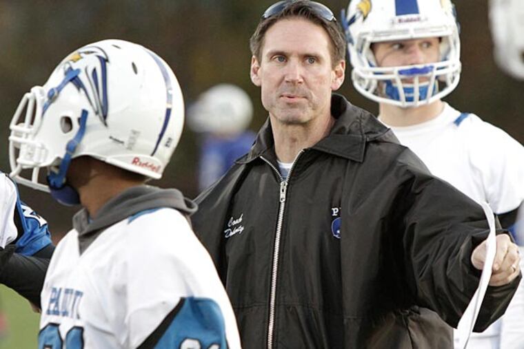 Paul VI head football coach John Doherty walks thru plays with his
team during practice. (Elizabeth Robertson/Staff Photographer)