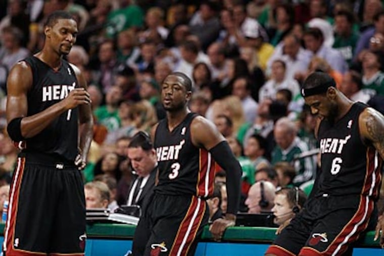 Chris Bosh, Dwyane Wade and LeBron James will be in the spotlight as the 76ers face the Heat tonight. (Winslow Townson/AP)