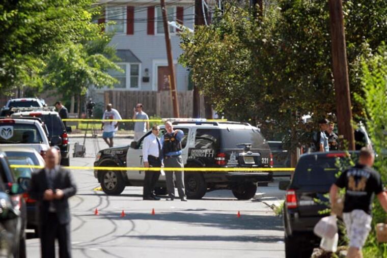 Trenton Police officers gather near 59 Hobart Avenue where two police officers were shot and taken to the hospital. The alleged shooter died at the scene Thursday August 15, 2013 ( DAVID SWANSON / Staff Photographer )