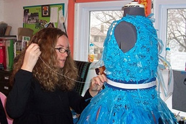 Cathy Kasdan sews a blue plastic ensemble. Kasdan, pursuing a master's degree in textile design at Kent State University, turned more than 400 plastic grocery bags into workable yarn. (Photo from Avid Kasdan)