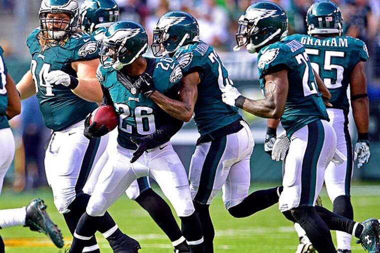 Philadelphia Eagles strong safety Walter Thurmond (26) is congratulated by his teammates after intercepting the ball during the fourth quarter against the New York Jets at MetLife Stadium. The Philadelphia Eagles defeated the New York Jets 24-17.