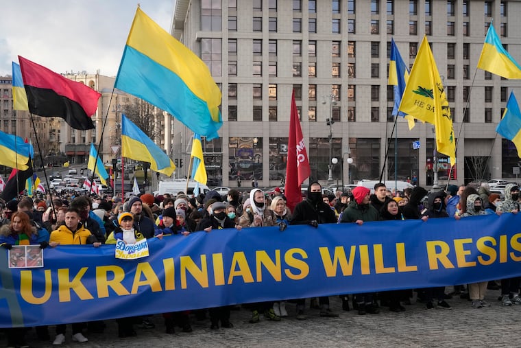 Ukrainians attend a rally in central Kyiv, Ukraine, Saturday, Feb. 12, 2022, during a protest against the potential escalation of the tension between Russia and Ukraine. Russian President Vladimir Putin and U.S. President Joe Biden are to hold a high-stakes telephone call on Saturday as tensions over a possibility imminent invasion of Ukraine escalated sharply and the U.S. announced plans to evacuate its embassy in the Ukrainian capital.