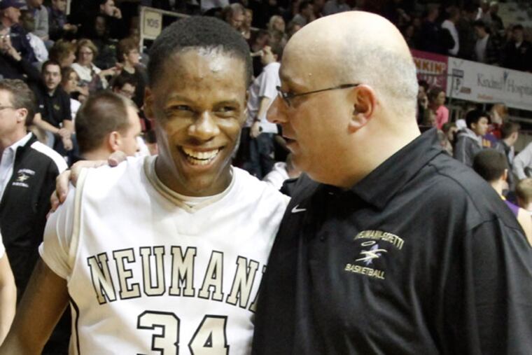 Neumann-Goretti assistant coach John Mosco talks with a smiling LaQuan Coaxum after N-G beat Roman Catholic in a Catholic League semifinal in February. (Elizabeth Robertson / Staff Photographer )