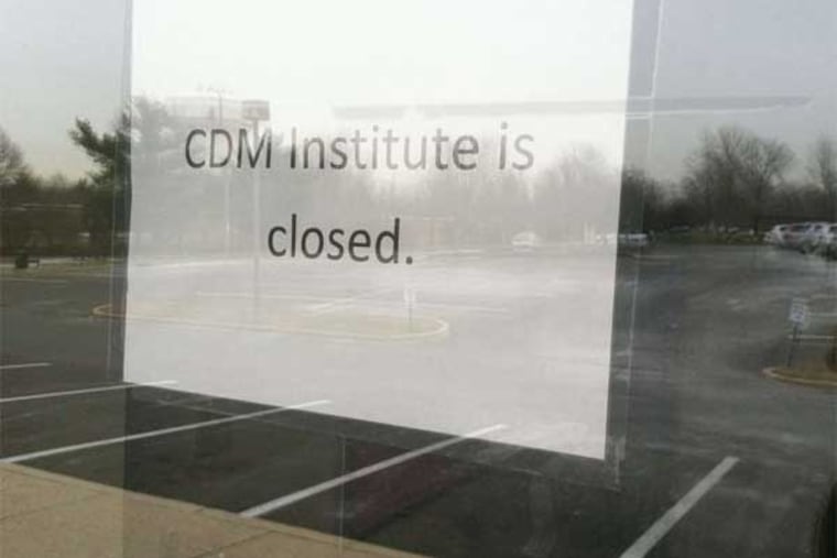 A sign on the door at the CDM Institute in Marlton announces that the school is closed.