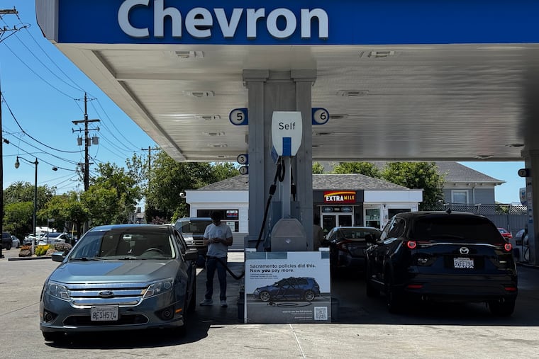 A sign blaming Sacramento policies for high gas prices is displayed at a Chevron gas station in Alameda, Calif., on Thursday, May 21, 2026.