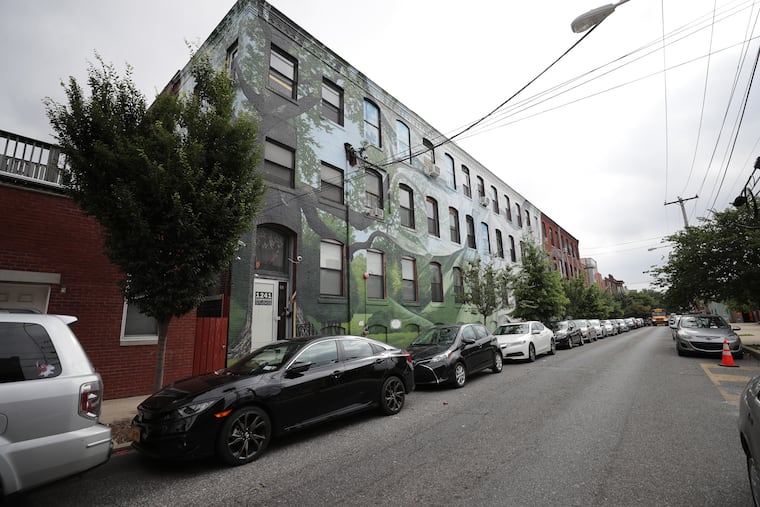 The exterior of 1241 Carpenter St., located in Philadelphia's Hawthorne neighborhood, a subsection of Bella Vista, showcases a mural by Phillip Adams, an artist who works with Mural Arts Philadelphia. The building provides studio space for about 50 Philadelphia artists.