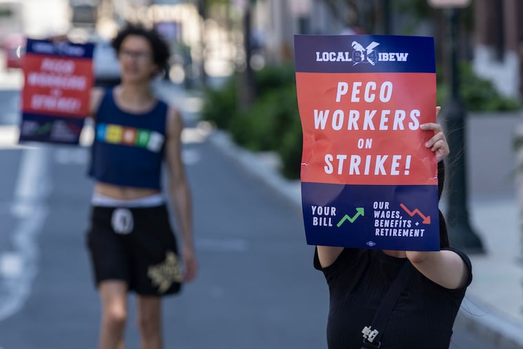 Members of the LBEW Local 614 go on strike outside of the PECO headquarters Saturday in Philadelphia.