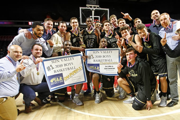 Sun Valley team members pose with the trophy after winning the District 1 Class 5A boys basketball championship.
