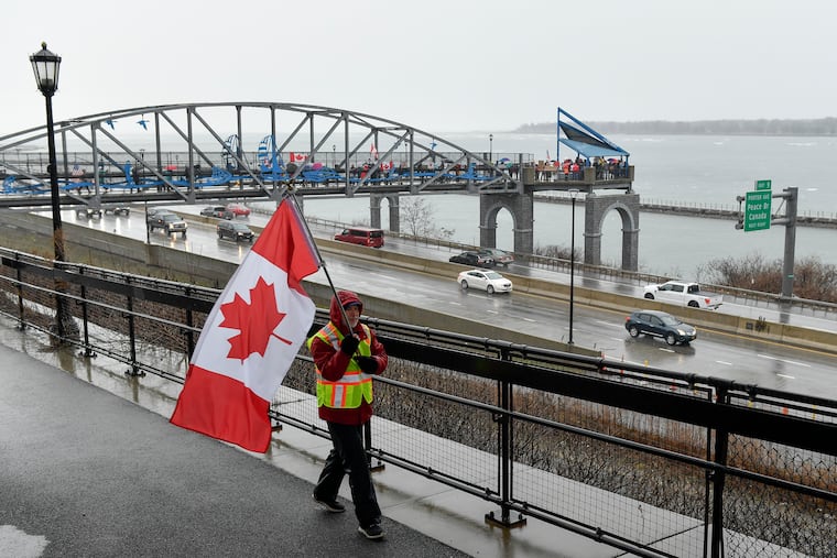 Elbows Up for Canada protesters gather near The Peace Bridge border crossing in Buffalo, N.Y., Wednesday, April 2, 2025. American physicians are expressing more interest in relocated north of the border. (AP Photo/Adrian Kraus)