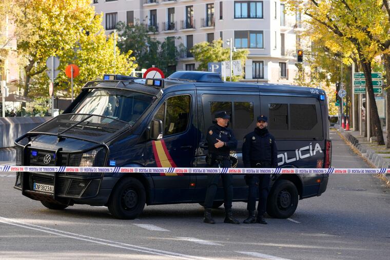 Police officers stand guard as they cordon off the area next to the U.S. embassy in Madrid, Spain, on Thursday.
