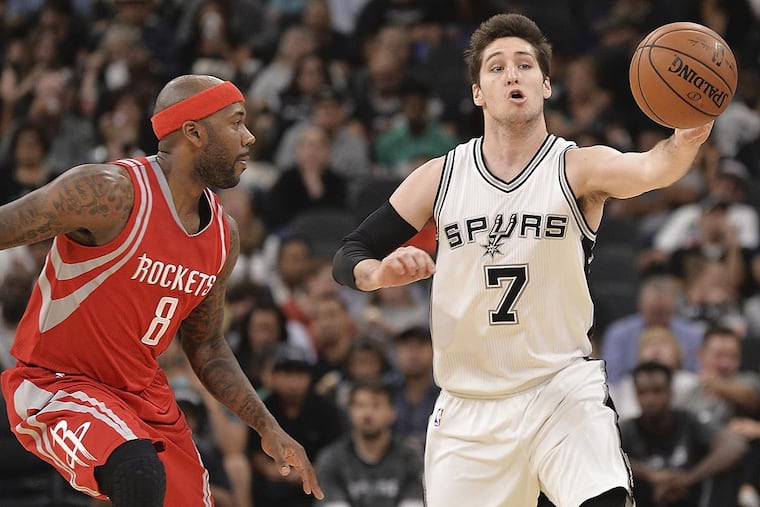 San Antonio Spurs guard Ryan Arcidiacono (7) evades Houston Rockets guard Bobby Brown during the second half of a preseason NBA basketball game, Friday, Oct. 21, 2016, in San Antonio.