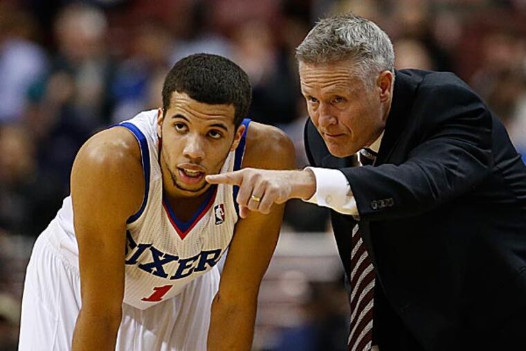 The 76ers' Michael Carter-Williams and Brett Brown. (Matt Slocum/AP)