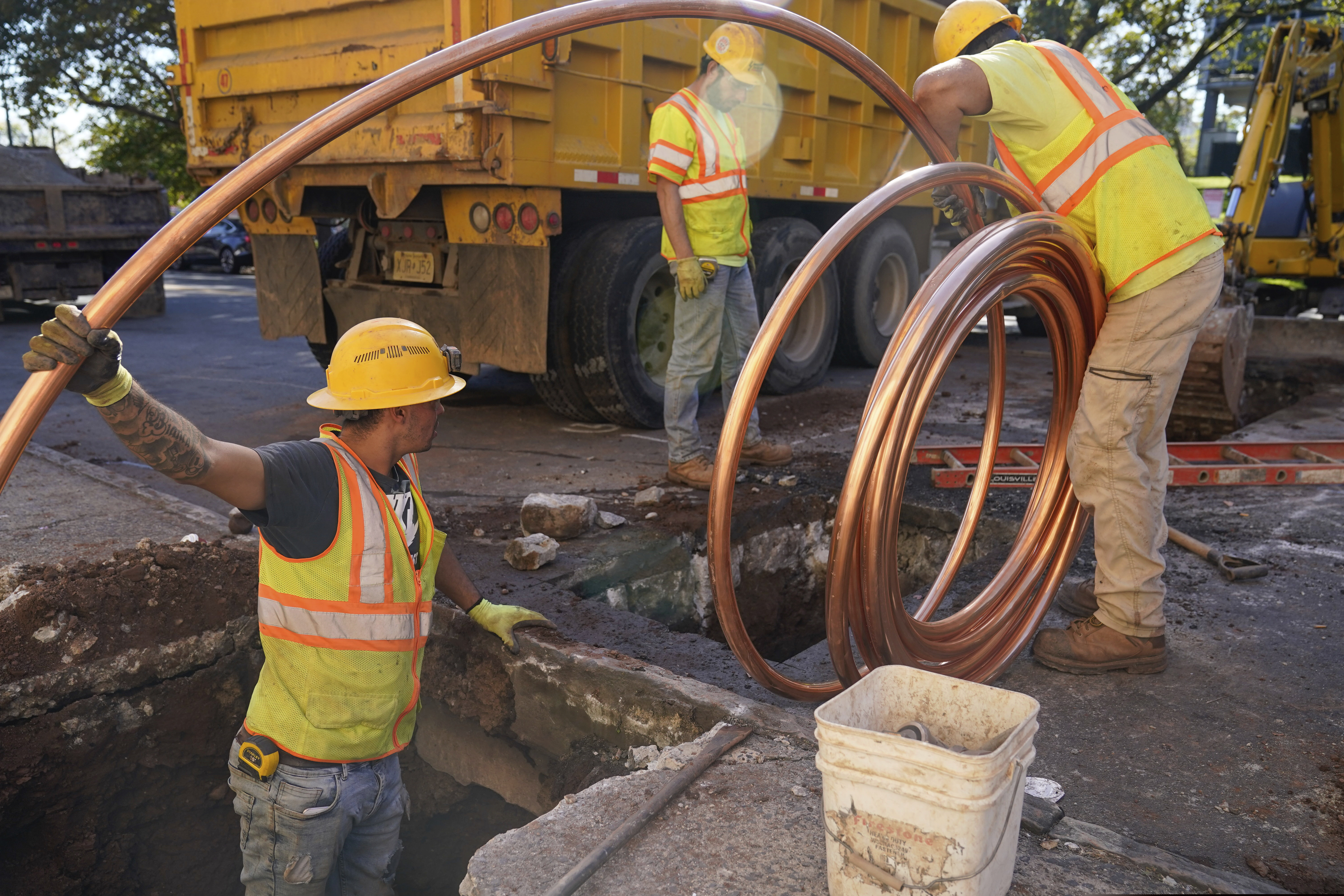Workmen preparing to replace older water pipes with a new copper one in Newark, N.J., in October.
