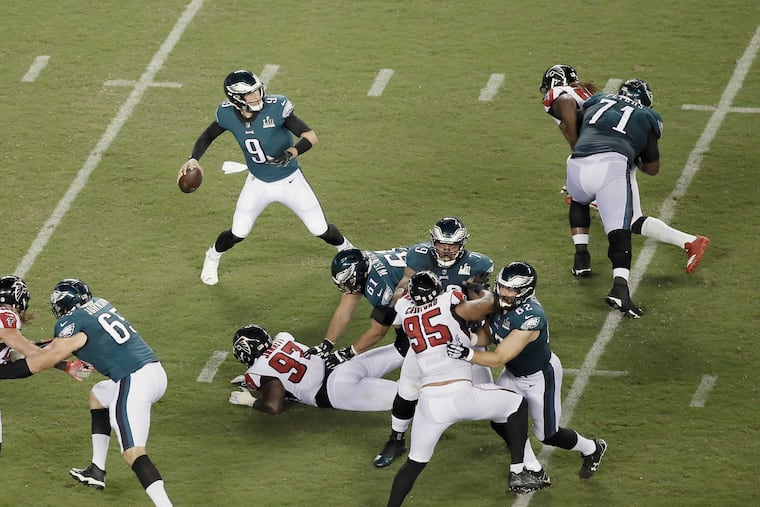 The Eagles offensive line holds off Atlanta long enough so that quarterback Nick Foles can get a pass away during the second half of the Atlanta Falcons at Phila. Eagles NFL game at Lincoln Financial Field in Philadelphia, Pa. on September 6, 2018, ELIZABETH ROBERTSON / Staff Photographer