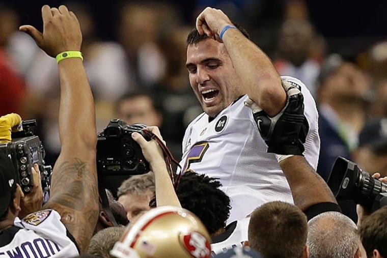 Baltimore Ravens quarterback Joe Flaccois lifted into the air by teammates after defeating the San Francisco 49ers. (Bill Haber/AP)