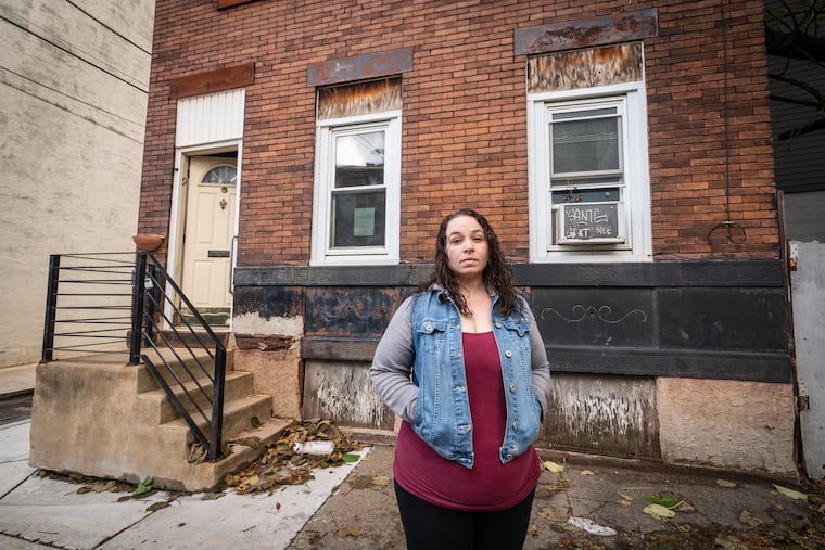 Linsey Franklin stands in front of her family's former home in Fishtown. Her advocacy, after she had to fight an Act 135 petition, sparked City Council to call a hearing about the law.