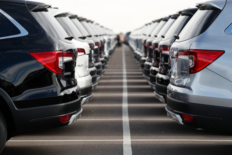FILE photo shows lines of unsold sports-utility vehicles sit at a dealership in Colorado.