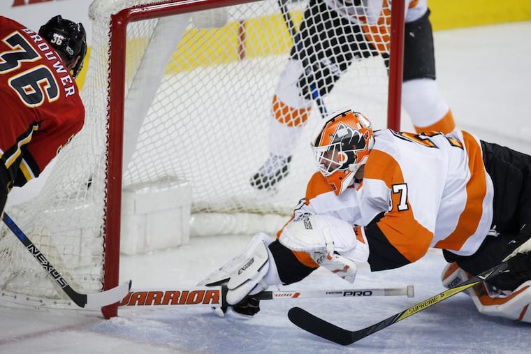 Goalie Brian Elliott makes a diving save Monday in Calgary. He has started 11 of the last 13 games.