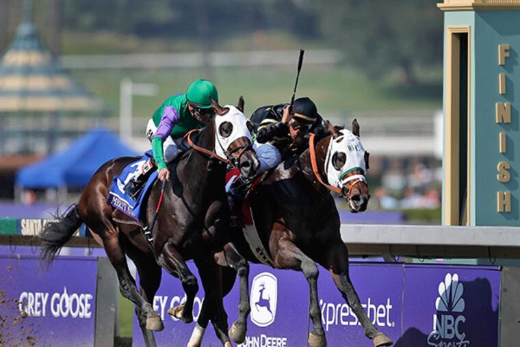 Hightail, right, ridden by Rajiv Maragh noses ahead of Merit Man (3), ridden by Patrick Valenzuela, at the wire to win the Juvenile Sprint horse race at the Breeders' Cup, Friday, Nov. 2, 2012, in Arcadia, Calif. (AP Photo/Jae C. Hong)