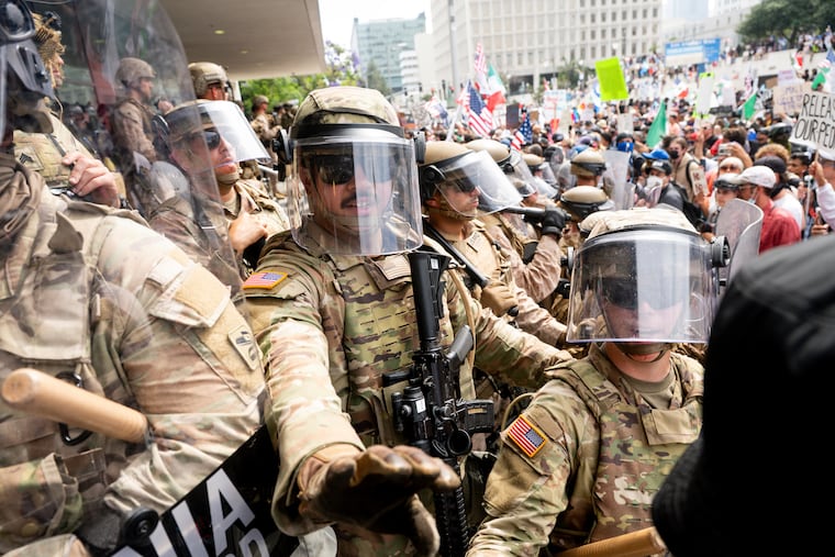 California National Guard and Marines hold back demonstrators at the Federal Building during a June 14 protest in Los Angeles.