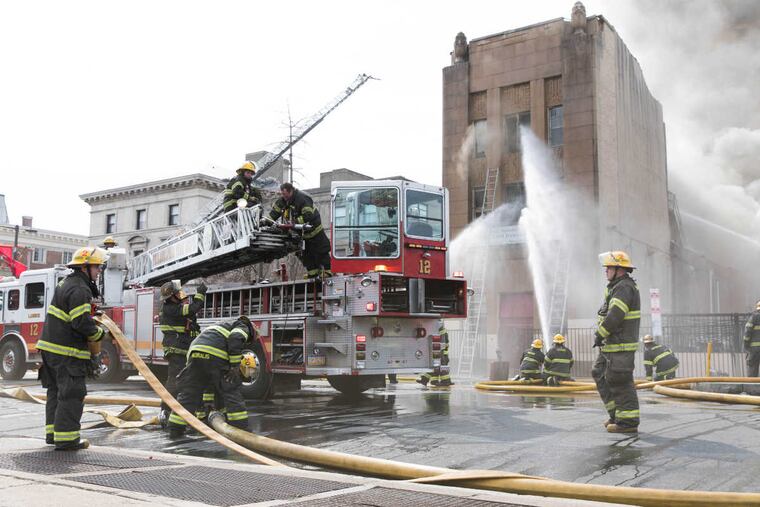 Firefighters work to put out a fire that erupted at the Original Apostolic Faith Church of the Lord Jesus on North Broad Street on Thursday afternoon, March 29, 2018.