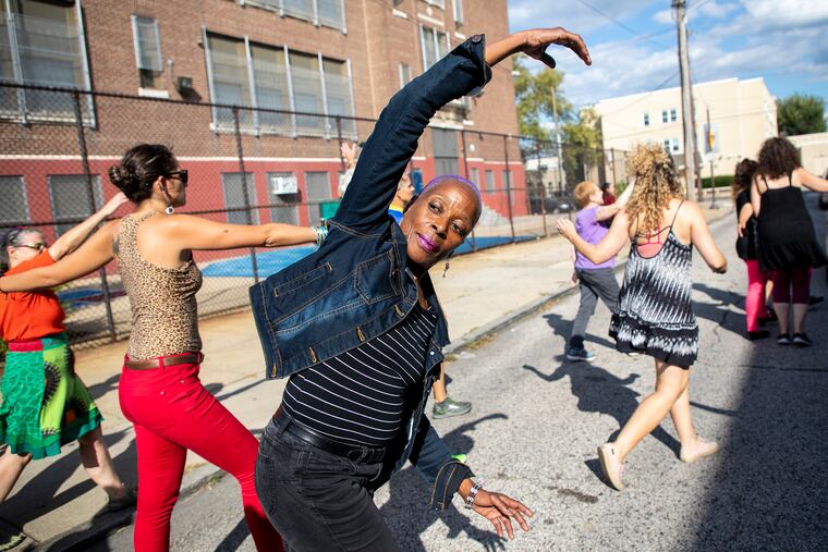 Rhonda Moore, 61, performs along Vollmer Street in South Philadelphia as part of last year's Fringe Festival.