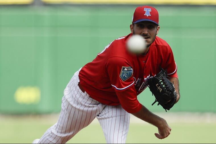 Phillies pitcher Zach Eflin throws a the first-inning warm-up pitch against the Baltimore Orioles during a spring training game at Spectrum Field in Clearwater, FL on Saturday, February 24, 2018.