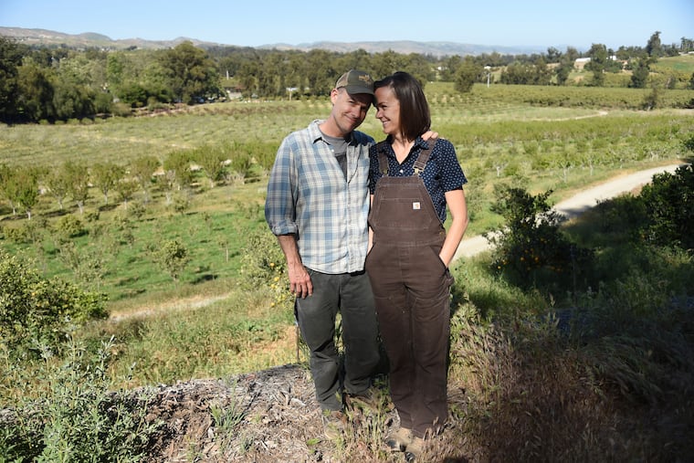 This April 17, 2019 photo shows John Chester, left, and his wife Molly, of the documentary film "The Biggest Little Farm," at Apricot Lane Farms in Moorpark, Calif. (Photo by Chris Pizzello/Invision/AP)