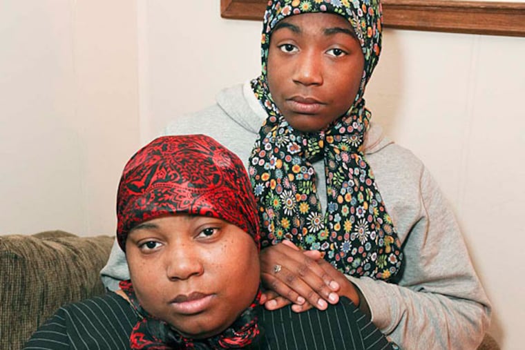 Tashiana Haggins-Montgomery and her daughter, Tashiyya Haggins, 14, at their home in Mayfair. They say that officer Tamika Gross brought her suspended 16-year-old daughter to school to fight and then jumped into the brawl when her daughter began losing.