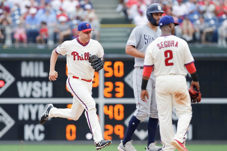 Phillies pitcher Jared Hughes sprints toward the pitchers mound with Phillies shortstop Jean Segura and San Diego Padres Eric Hosmer wait at second base in the sixth-inning on Sunday, August 18, 2019 in Philadelphia. Hughes replaced starting pitcher Jason Vargas.