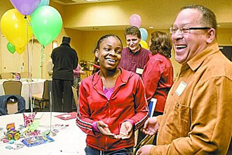 Jessica Jones, 12, and Phillip Carey of Cheltenham get acquainted at the FACE2FACE "match" party between older kids in foster care and prospective adoptive parents. (Ed Hille / Staff Photographer)
