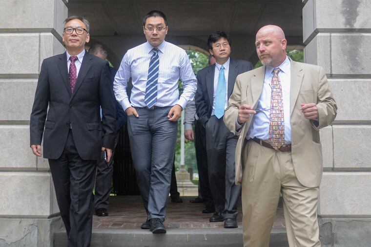 Principal of Haddonfield Memorial High School Chuck Klaus, right, leads a tour around Haddonfield Memorial High School on July 2, 2015, for Chinese dignitaries looking to send high school students to study at HMHS for a year. ( BEN MIKESELL / Staff Photographer )