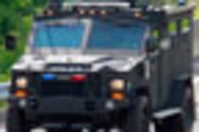 Summary: Armed NJ police officer barricaded in Doylestown home
CAPTION -- One of Police Armed car is passing by the Wells Rd.
( AKIRA SUWA / Staff Photographer )