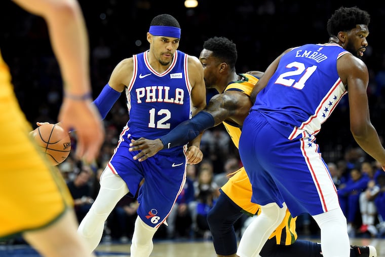 Sixers center Joel Embiid (right) sets a pick for Tobias Harris, who scored 10 of his team-high 26 points in the fourth quarter.