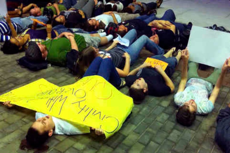 In support of safe places for gay students, a group joins in a "lie-in" near the student center at Rutgers University. The rally was in response to the suicide of Rutgers student Tyler Clementi.