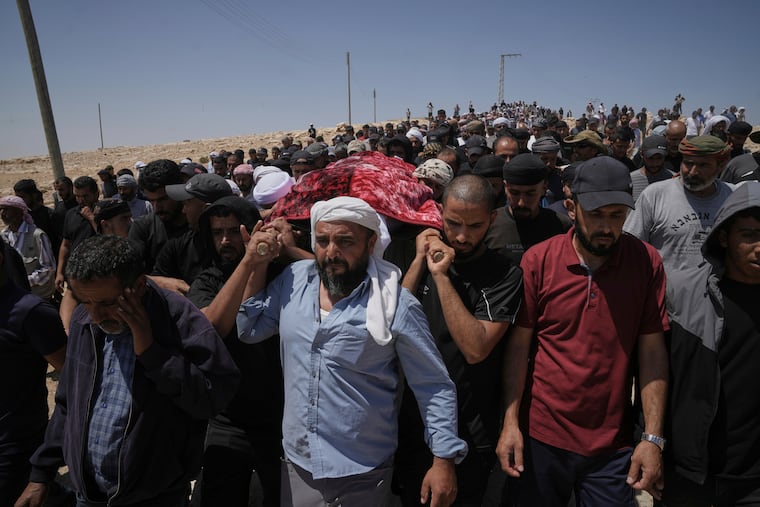 Mourners carry the body of Palestinian activist Awdah Hathaleen during his funeral in the West Bank Bedouin village of Umm al-Khair, Aug. 7, 2025.