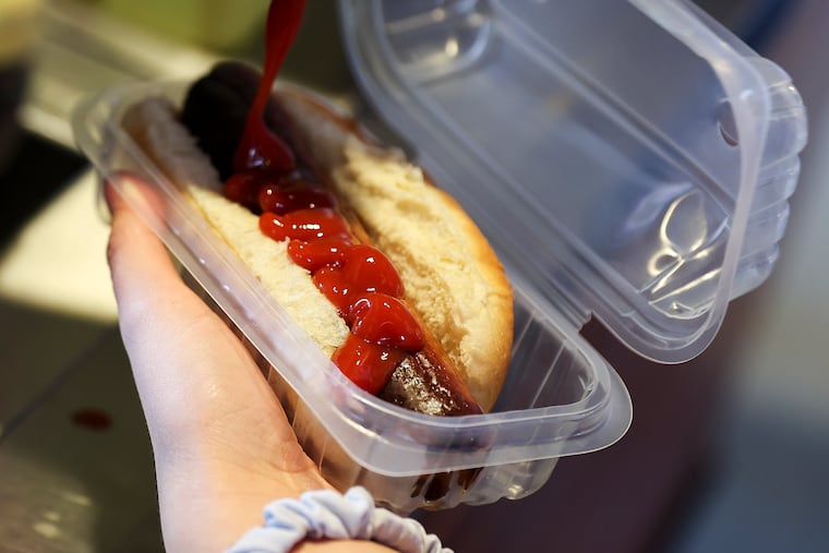 A fan slathers a hot dog in ketchup before the Philadelphia Phillies game against the Pittsburgh Pirates at Citizens Bank Park in Philadelphia, Pa. on Sunday, April 14, 2024. The Pirates defeated the Phillies, 9-2.