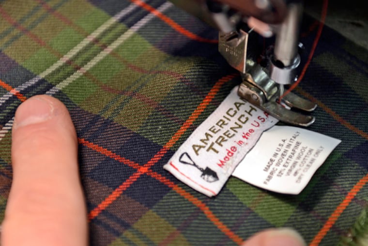 Gary Weiss with Matthew Cole Sewing sews an American Trench label on one of the scarfs he produces for Jacob Hurwitz. Hurwitz's American coats got a robust start with a Kickstarter fund-raising campaign and now reaches a local manufacturing goal to the delight of its founders. (TOM GRALISH/Staff Photographer)