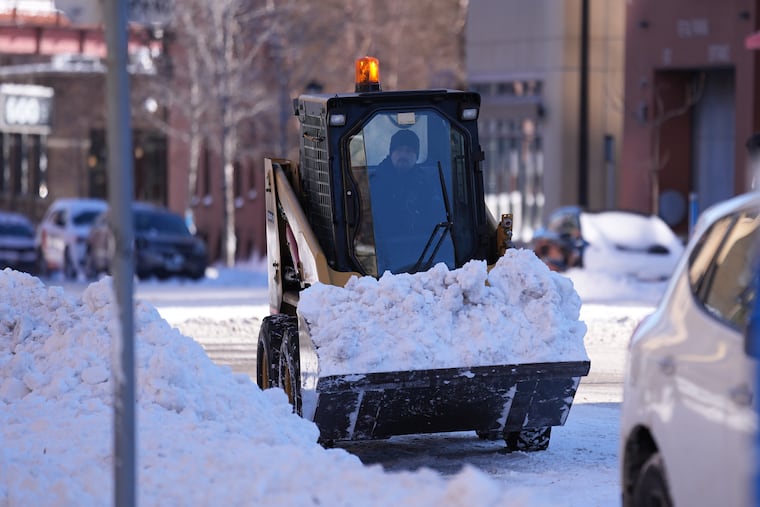 A snowplow works after a snowstorm Monday, March 16, 2026, in Minneapolis.