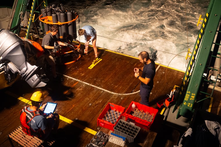 The research team on the F.G. Walton Smith — clockwise from lower left, Denis Volkov, Ryan Smith, Tyler Christian, and Jay Hooper — collects water samples in the early-morning hours.