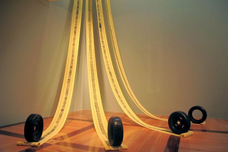 Betsabeé Romero’s “Ciudades que se van (Cities that go away),” 2004, carved tires and imprints on domestic fabrics.