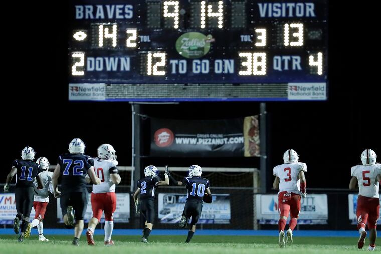 Williamstown’s Brody Colbert (No. 2) and Jonathon Wood (No. 10) high five as Wood runs in for a touchdown in the 4th quarter of the the Braves' 28-21 win over Lenape on Set. 27. The team meet again this weekend in the South Jersey Group 5 title game.