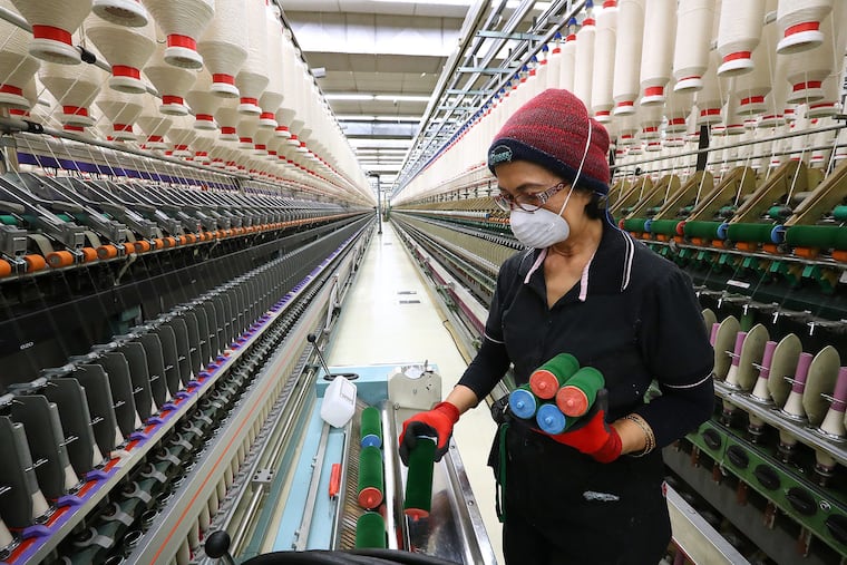 Asmarajati Djain works cleaning automated and faster specialty yawn spinning machines at Buhler Quality Yarns Corporation on March 11, 2019, in Jefferson, GA. (Curtis Compton/Atlanta Journal-Constitution/TNS)