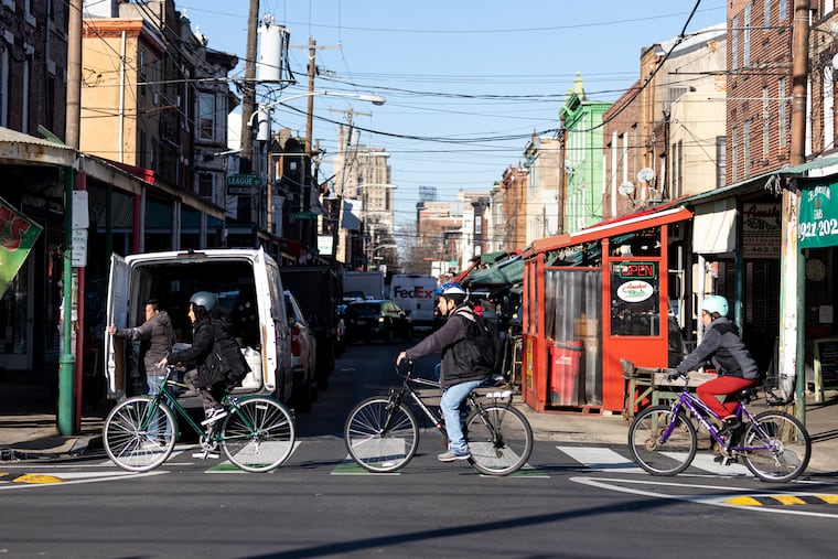 (From left to right) Sarahi Franco-Morales, 17, of South Philadelphia, Pa., daughter, Martin Franco, dad, and Dora Morales, mom, ride their bikes along Washington Avenue for a posed photo in Philadelphia, Pa., on Wednesday, Feb. 1, 2023. The three commute everywhere by bike.
